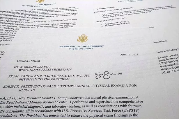 The report on President Donald Trump's health after his physical on April 11, 2025, at Walter Reed National Military Medical Center, released by the White House on behalf of his physician Navy Capt. Sean Barbabella, is photographed Sunday, April 13, 2025. (AP Photo/Jon Elswick)