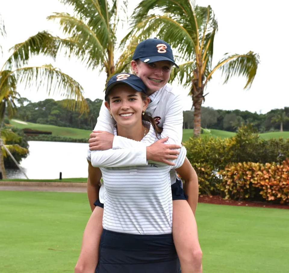 Benjamin's Kai Trump lifts teammate Reese McMillan into the air as the Buccaneers celebrate their district title at Trump International (Oct. 28, 2024).