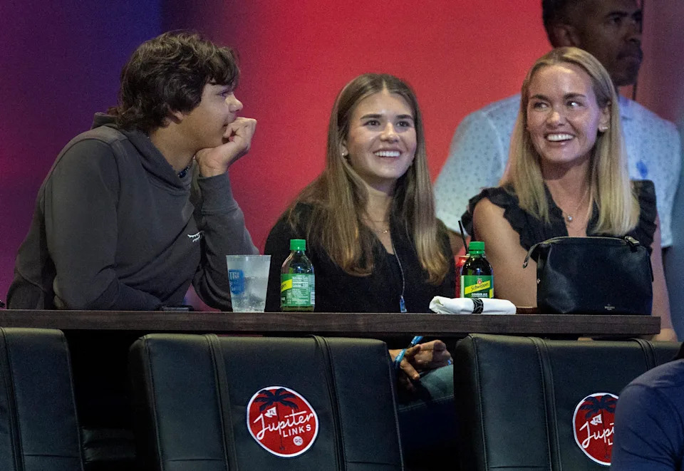 Charlie Woods talks to Kai Trump, center, and her mom Vanessa Trump at a TGL match between Jupiter Links GC and Atlanta Drive GC at SoFi Center on March 4, 2025, in Palm Beach Gardens, Florida.