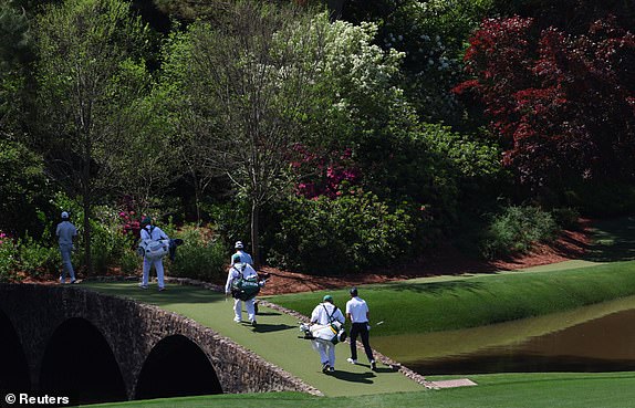 Golf - The Masters - Augusta National Golf Club, Augusta, Georgia, U.S. - April 11, 2025 England's Justin Rose walks across the Hogan Bridge on the 12th hole during the second round REUTERS/Mike Segar