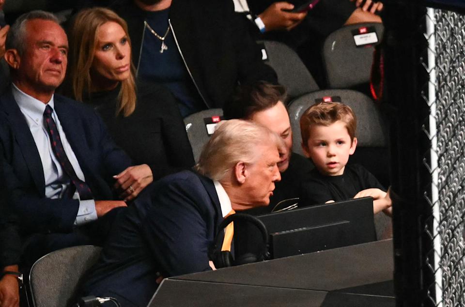 US President Donald Trump speaks with Elon Musk's son X Æ A-12 as they sit with US Secretary of Health and Human Services Robert F. Kennedy Jr. and his wife actress Cheryl Hines during UFC 314 at the Kaseya Center in Miami, Florida, on April 12, 2025. (Photo by Mandel NGAN / AFP) (Photo by MANDEL NGAN/AFP via Getty Images)