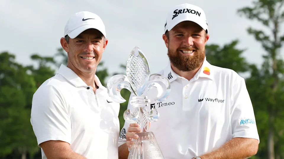 Rory McIlroy and Shane Lowry pose with the Zurich Classic of New Orleans trophy in 2024