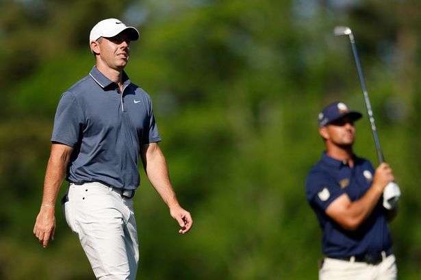 AUGUSTA, GEORGIA - APRIL 13: Rory McIlroy of Northern Ireland walks as Bryson DeChambeau of the United States plays a shot on the 12th hole during the final round of the 2025 Masters Tournament at Augusta National Golf Club on April 13, 2025 in Augusta, Georgia. (Photo by Harry How/Getty Images)