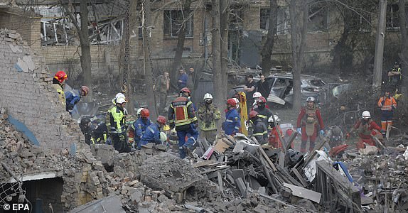 epaselect epa12050898 Ukrainian rescuers work at the site of a rocket strike that hit a residential building in Kyiv, Ukraine, 24 April 2025, amid the ongoing Russian invasion. Russia launched a large-scale overnight attack using a combination of drones and various types of rockets. At least nine people were killed and 63 others injured, including six children, in the strike on the residential building, according to the State Emergency Service report. EPA/SERGEY DOLZHENKO