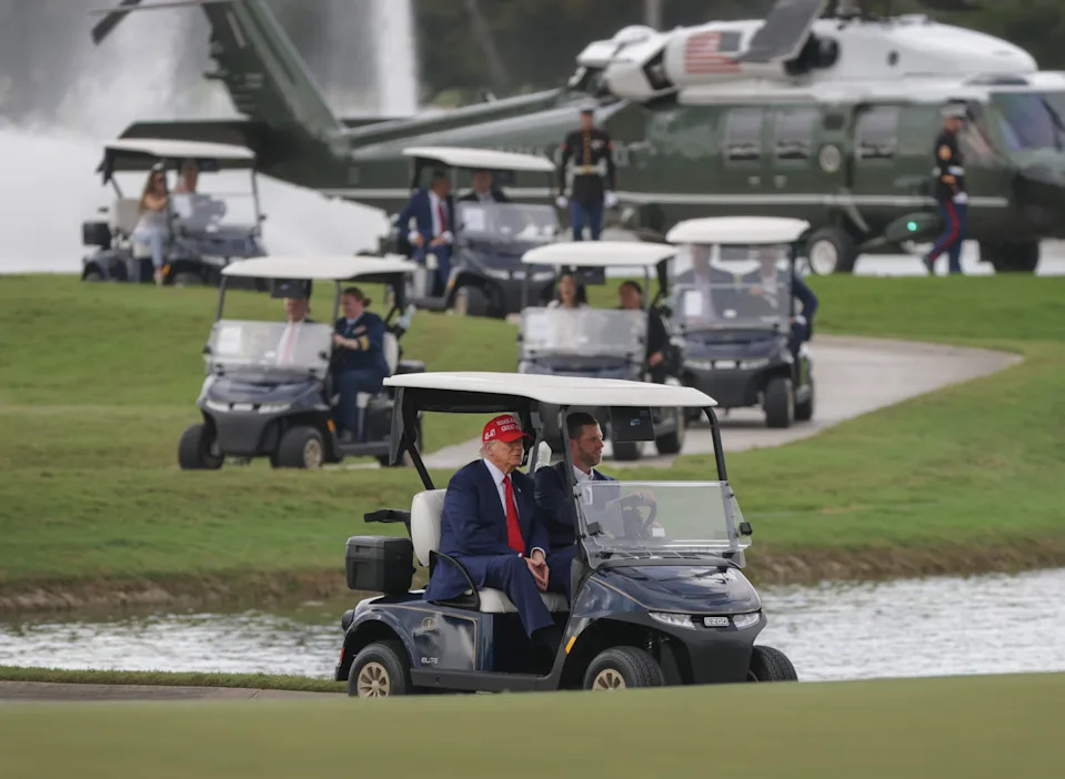DORAL, FLORIDA - APRIL 03: U.S. President Donald Trump and his son, Eric Trump, drive in a golf cart after he arrived on Marine One at the LIV Golf tournament being held at his Trump National Doral Golf Club on April 03, 2025 in Doral, Florida. Yesterday, Trump declared a U.S. economic emergency and announced sweeping tariffs of at least 10%, with rates even higher for 60 countries that have a high trade deficit with the U.S. The tariffs will affect electronics, automobiles, clothing and shoes, wines and spirits, and Swiss watches (Photo by Joe Raedle/Getty Images)