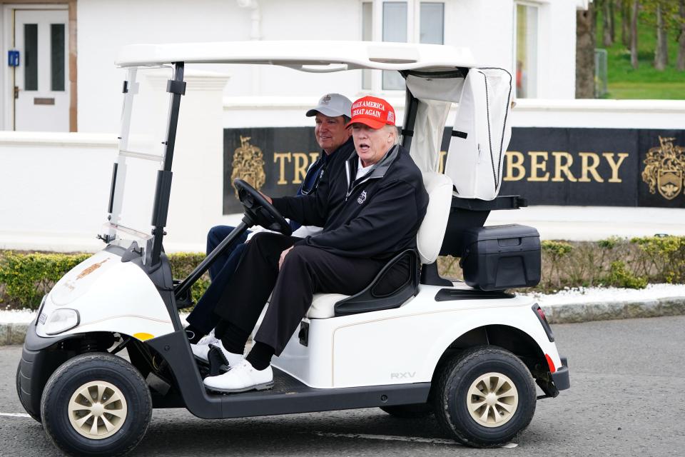 Donald Trump in a golf cart.