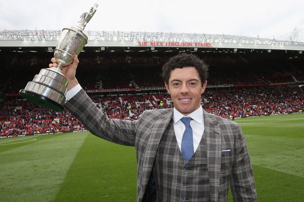 MANCHESTER, ENGLAND - AUGUST 16:  Golfer Rory McIlroy poses with the Open Golf Claret Jug trophy at halftime of the Premier League match between Manchester United and Swansea City at Old Trafford on August 16, 2014 in Manchester, England.  (Photo by John Peters/Manchester United via Getty Images)