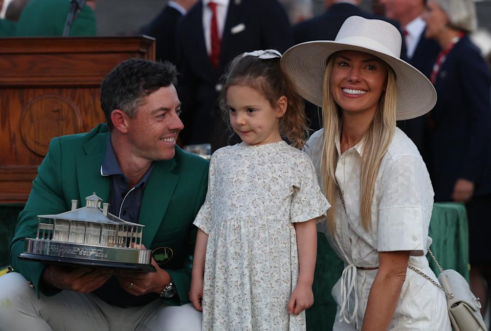 Rory McIlroy celebrates wearing with his daughter and wife after winning the Masters.