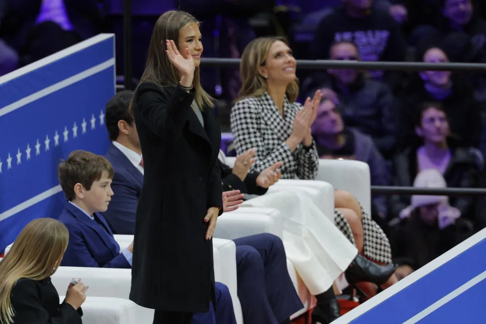 Kai Trump, standing next to Bettina Anderson, girlfriend of Donald Trump Jr., waves at Capital One arena on the inauguration day of Donald Trump's second presidential term, in Washington, D.C., on Jan. 20, 2025.
