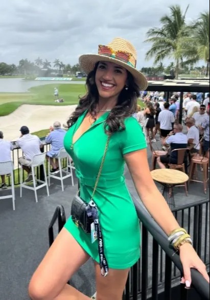 Woman in green dress at a golf tournament.
