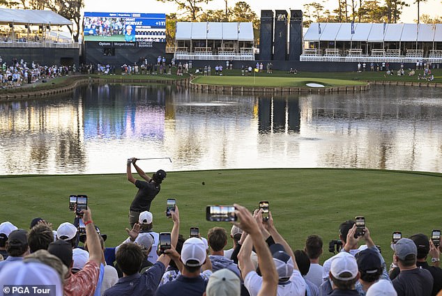 Horvat hits his tee shot towards the famous island green on the 17th hole at TPC Sawgrass