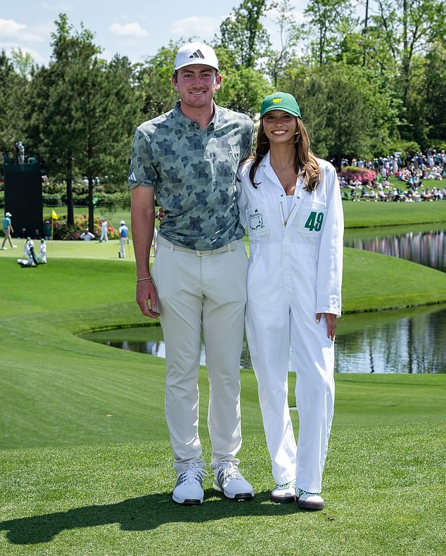 The 21-year-old is pictured with girlfriend Erika Baker at the Par-3 Contest on Wednesday