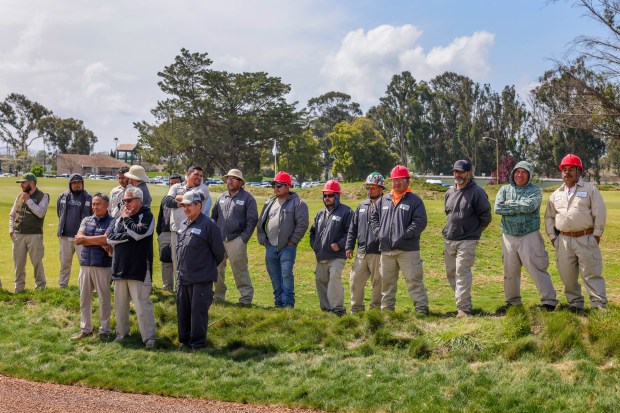 Greenskeepers watch the North Course unveiling ceremony at Corica Park...