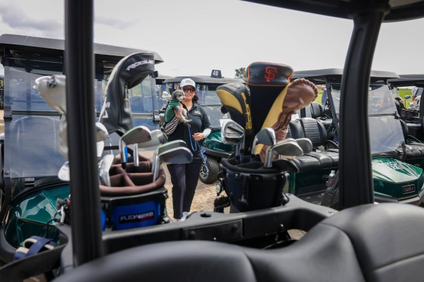 Golfer Melissa Brown, of Oakland, and her amaltipoo dog, Moby,...
