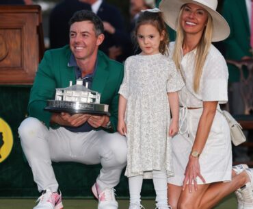AUGUSTA, GEORGIA - APRIL 13: (L-R) Rory McIlroy of Northern Ireland poses with daughter Poppy and wife Erica Stoll holding the Masters trophy during the Green Jacket Ceremony after winning the 2025 Masters Tournament at Augusta National Golf Club on April 13, 2025 in Augusta, Georgia. (Photo by Michael Reaves/Getty Images)