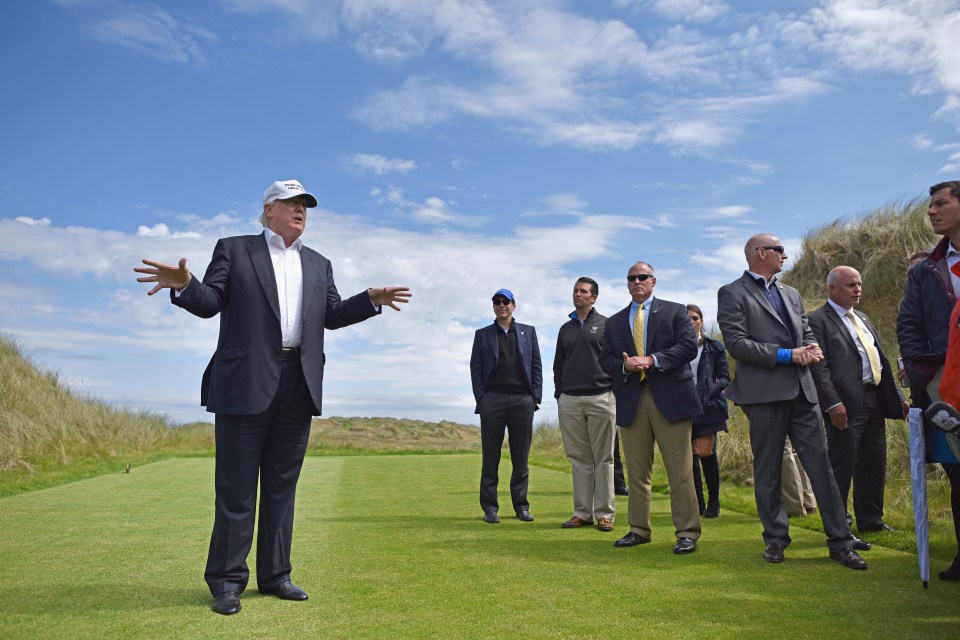 Donald Trump speaking at a golf course.