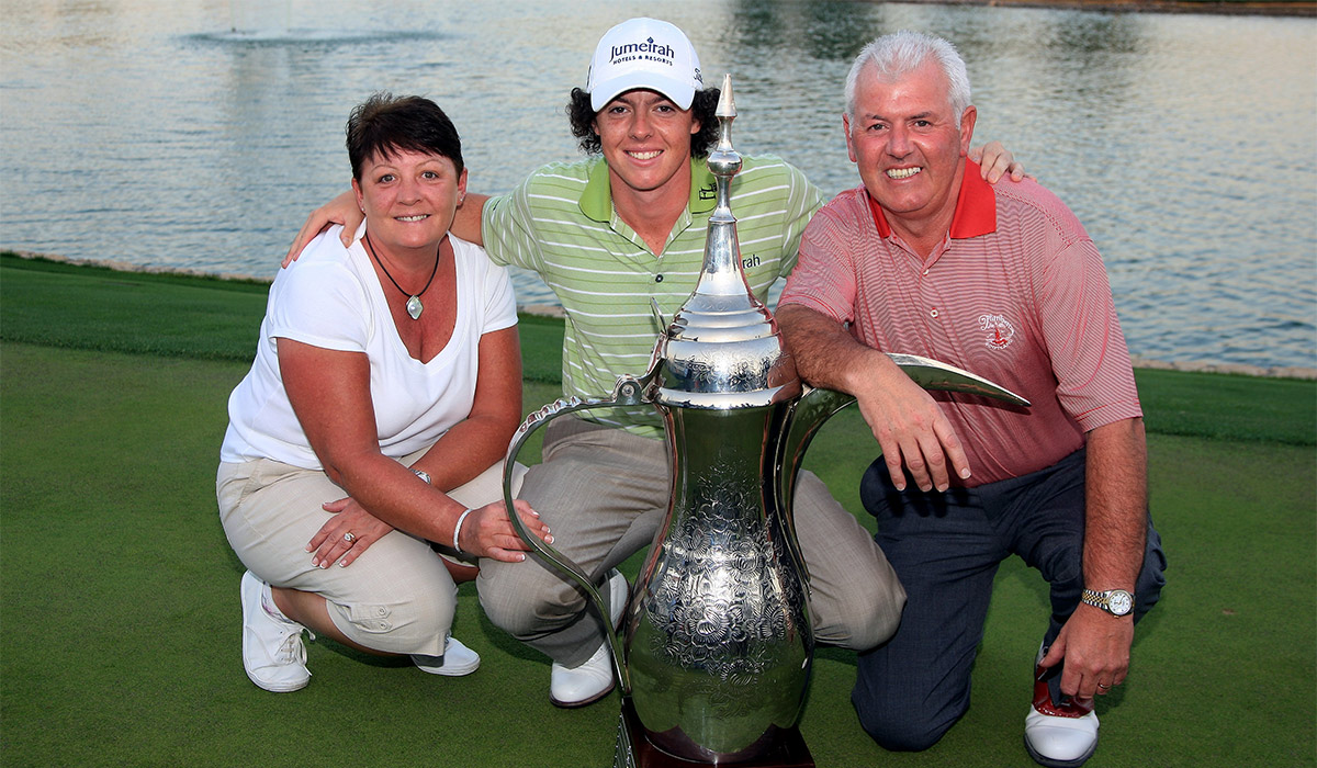 Rory McIlroy of Northern Ireland poses with the trophy alongside his parents Rosie and Gerry after winning the 2009 Dubai Desert Classic on the Majilis Course at the Emirates Golf Club. Pic: Getty Images