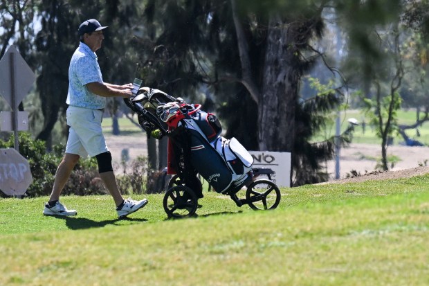 A golfer walks through the El Prado Golf Course on...