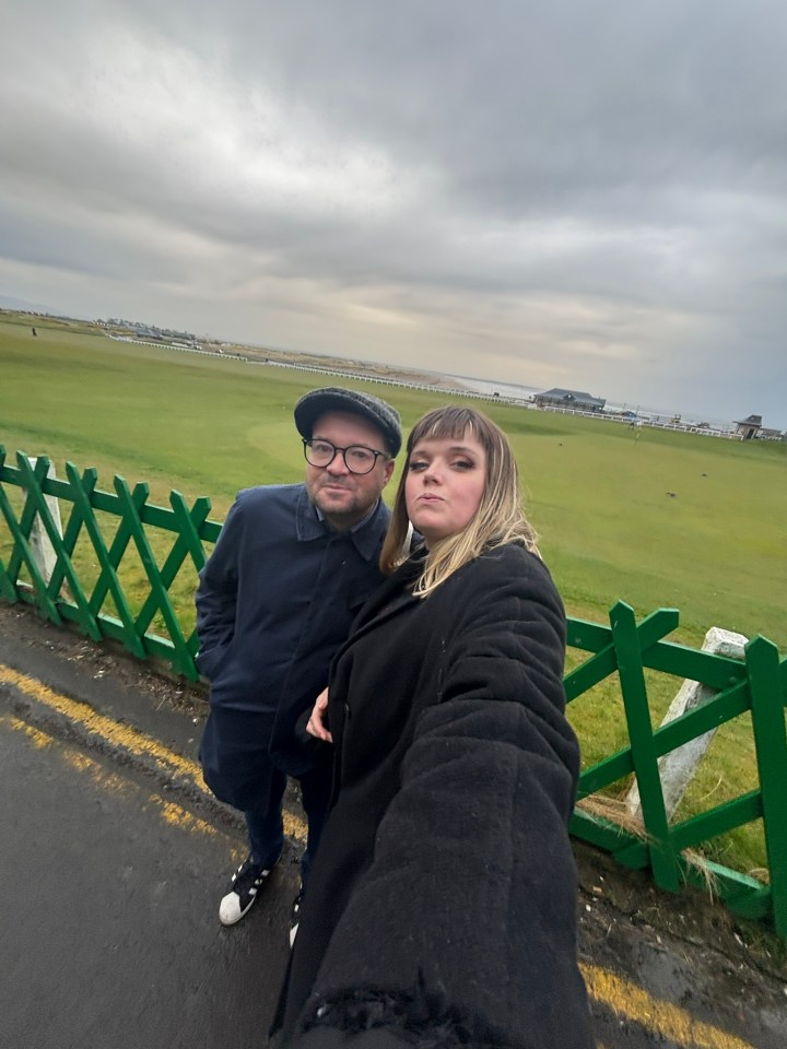 Couple taking a selfie at a golf course.