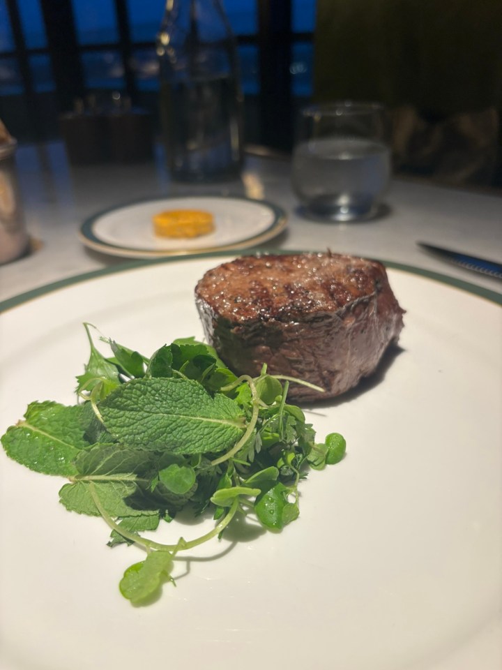 Steak with herbs on a plate.