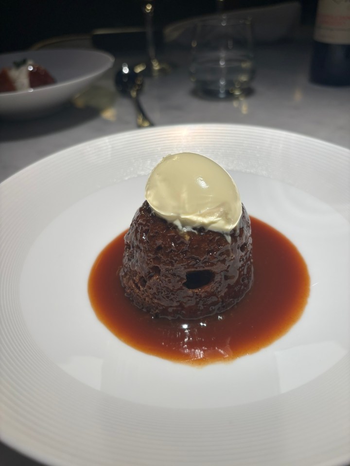 Chocolate pudding with ice cream and sauce.