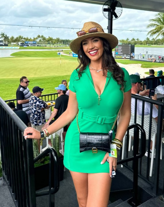 Woman in green dress at a golf tournament.