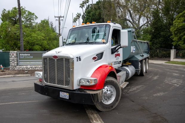 Trucks bring debris from the Eaton fire area to the...