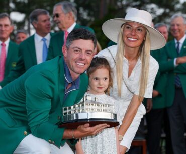 Rory McIlroy of Northern Ireland poses with daughter Poppy and wife Erica Stoll holding the Masters trophy during the Green Jacket Ceremony after winning the 2025 Masters Tournament