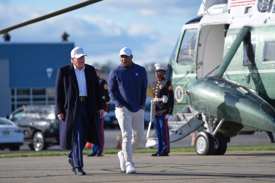 President Donald Trump, left, walks with Philadelphia Eagles football player Saquon Barkley before boarding Air Force One at Morristown Municipal Airport, Sunday, April 27, 2025, in Morristown, N.J. (AP Photo/Evan Vucci)