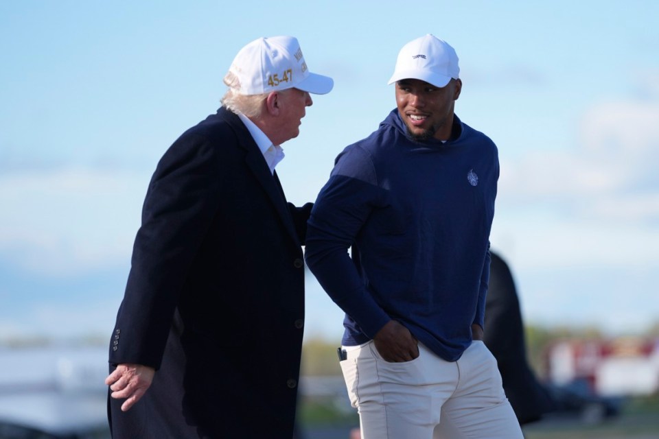 President Donald Trump, left, walks with Philadelphia Eagles football player Saquon Barkley before boarding Air Force One at Morristown Municipal Airport, Sunday, April 27, 2025, in Morristown, N.J. (AP Photo/Evan Vucci)