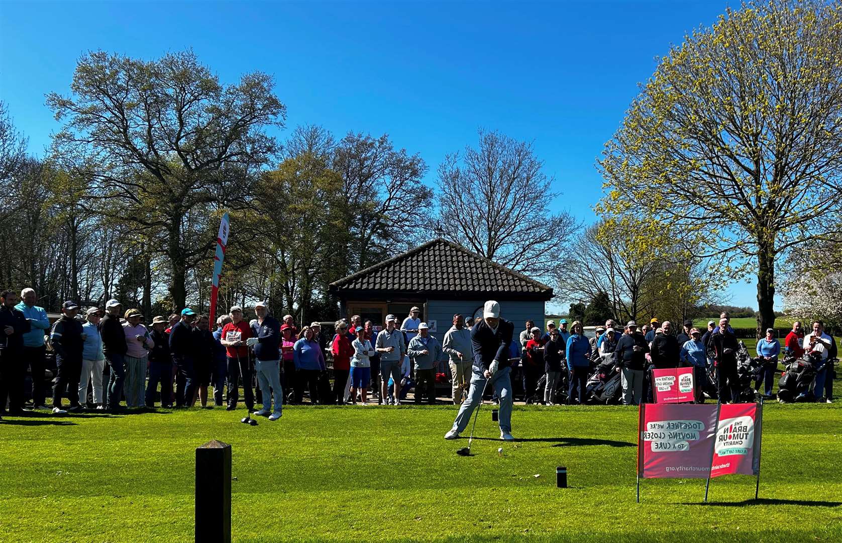 Men's captain Garry Clark driving in with a large crowd watching on at Bury St Edmunds GC Picture: Molly Smith