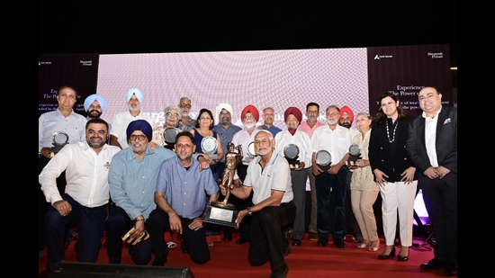 Winners of the Milkha Singh Memorial Golf Tournament posing with trophy at Chandigarh Golf Club on Thursday. (Ravi Kumar/HT)