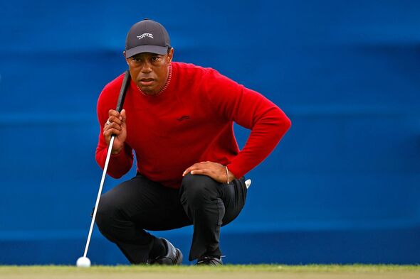 Tiger Woods lines up a putt