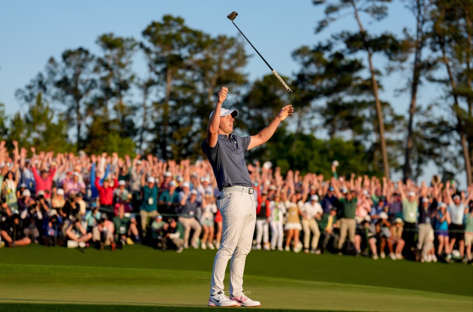 Rory McIlroy celebrating on the 18th green after winning a playoff at the Masters Tournament.
