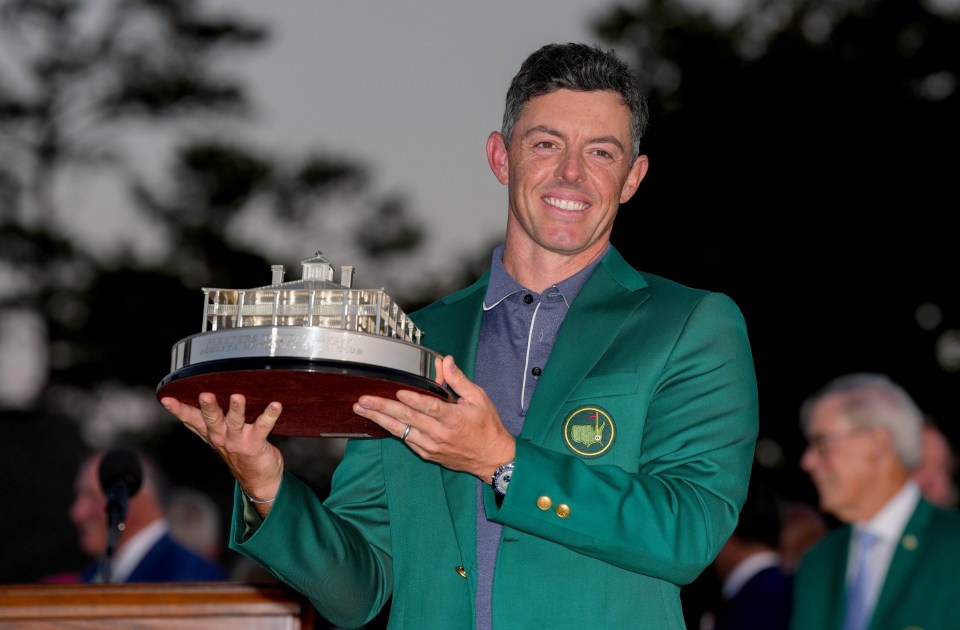 Rory McIlroy holding the Masters Championship trophy.