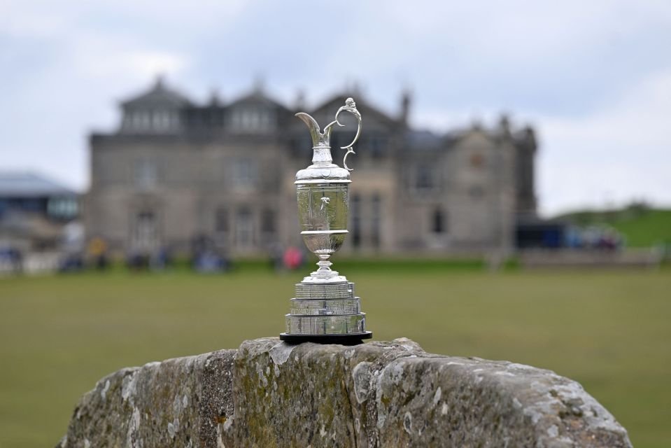 The Claret Jug trophy on a stone wall.