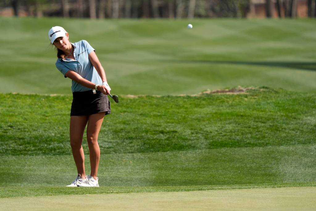 Kai Trump chips onto No. 18 green during the first round of the Junior Invitational at Sage Valley Golf Club.