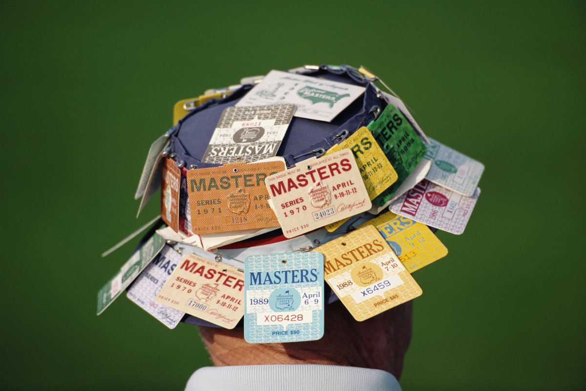 A spectator wears a hat covered in 