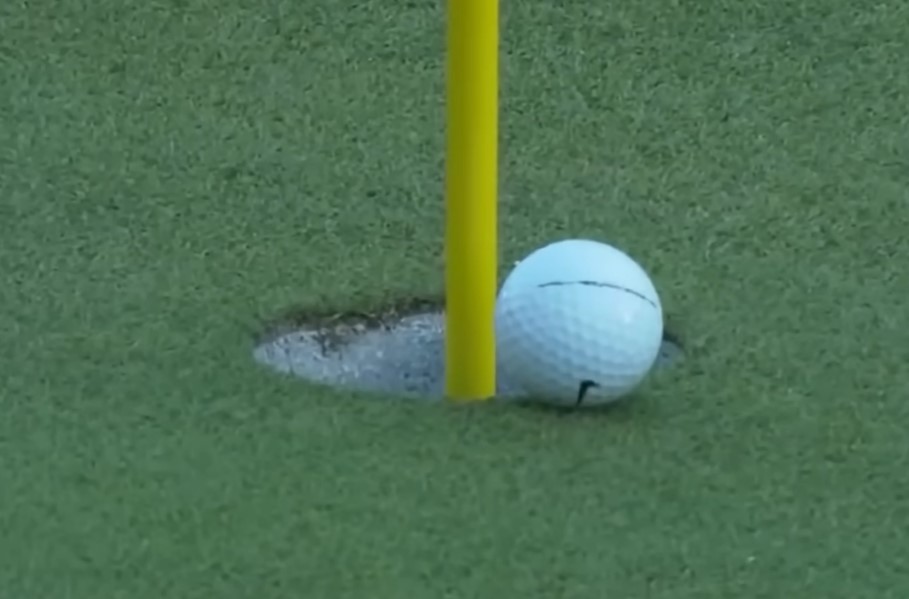 The ball peaked then slowly rolled toward the cup before almost stopping