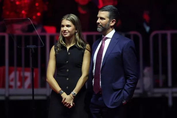 Donald Trump Jr. and his daughter Kai Madison Trump stand ton stage at President-elect Donald Trump's victory rally at the Capital One Arena on January 19, 2025 in Washington, DC
