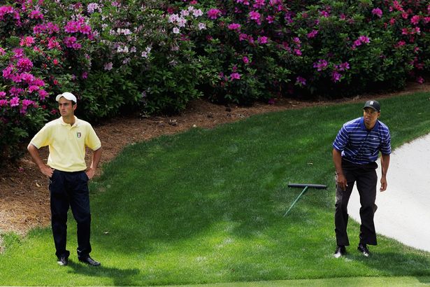 Tiger Woods and Amateur, Edoardo Molinari of Italy, wait on the 13th hole during the first round of The Masters at the Augusta National Golf Club on April 6, 2006 in Augusta, Georgia.