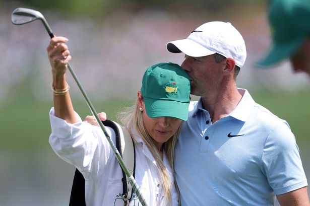 AUGUSTA, GEORGIA - APRIL 09: (R-L) Rory McIlroy of Northern Ireland kisses wife Erica Stoll during the Par Three Contest prior to the 2025 Masters Tournament at Augusta National Golf Club on April 09, 2025 in Augusta, Georgia. (Photo by Andrew Redington/Getty Images)