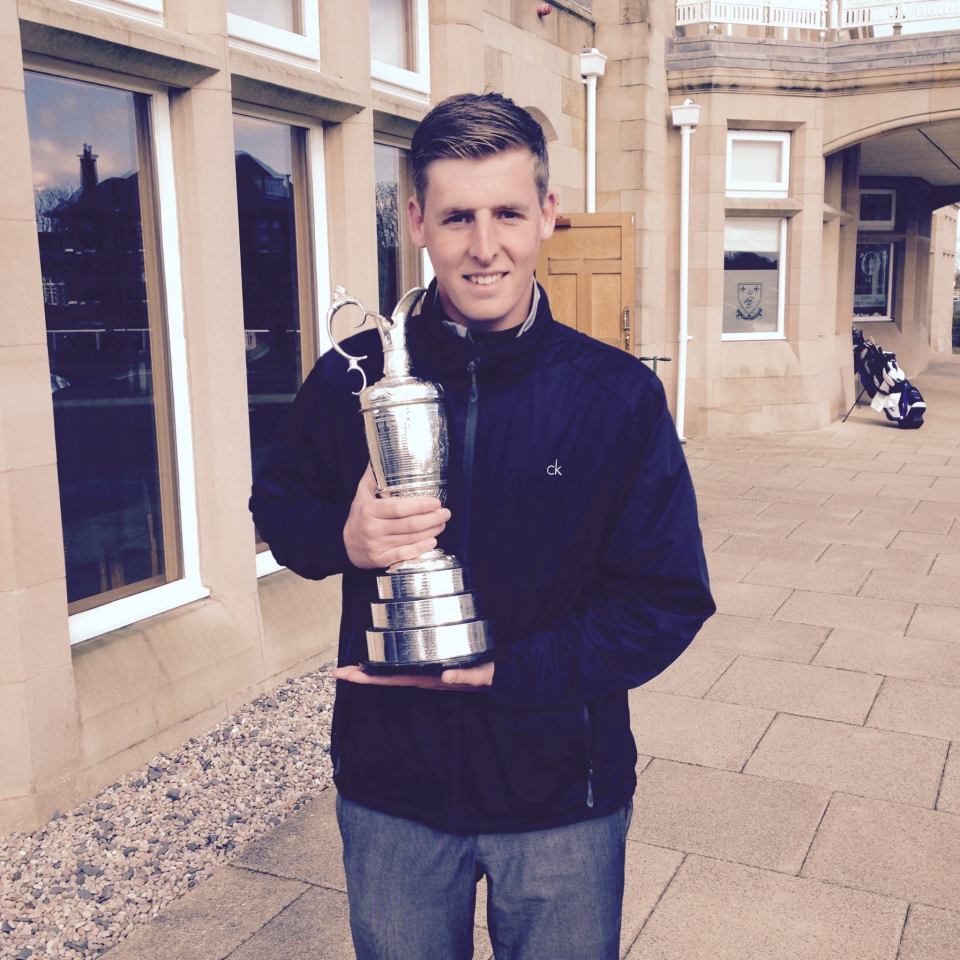 Man holding a golf trophy.