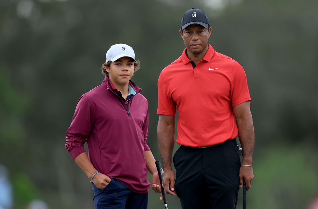 Charlie Woods of The United States prepares to putt on the 18th hole shadowed by his father Tiger Woods during the final round of the PNC Championship at The Ritz-Carlton Golf Club on December 17, 2023 in Orlando, Florida
