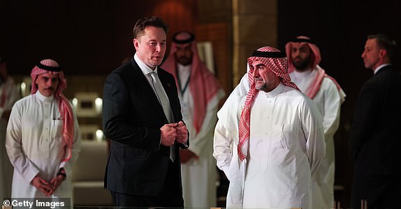 RIYADH, SAUDI ARABIA - MAY 13: Elon Musk, Tesla CEO and Senior Advisor to the President of the United States talks with Yasir bin Othman Al-Rumayyan, governor of the Public Investment Fund of Saudi Arabia as they view view an exhibit in the old district of Diriyah on the outskirts of the Saudi capital Riyadh on May 13, 2025, in Riyadh, Saudi Arabia. Trump begins a multi-nation tour of the Gulf region focused on expanding economic ties and reinforcing security cooperation with key U.S. allies.   (Photo by Win McNamee/Getty Images)