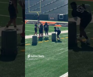 Bengals defensive line coach Jerry Montgomery with rookie def lineman as Shemar Stewart looks on