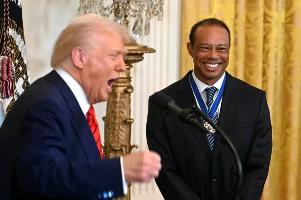 US President Donald Trump speaks alongside US golfer Tiger Woods