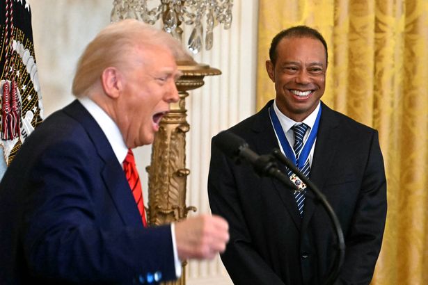 US President Donald Trump speaks alongside US golfer Tiger Woods