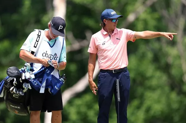 Rickie Fowler of the United States talks to his caddie on the fifth green during the first round of the Charles Schwab Challenge 2025 at Colonial Country Club