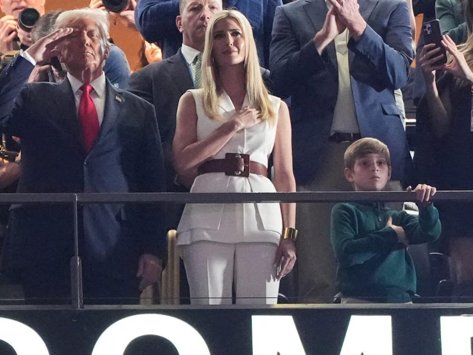 US President Donald Trump stands as US singer-songwriter Jon Baptiste performs the National Anthem ahead of Super Bowl LIX between the Kansas City Chiefs and the Philadelphia Eagles at Caesars Superdome in New Orleans, Louisiana, February 9, 2025